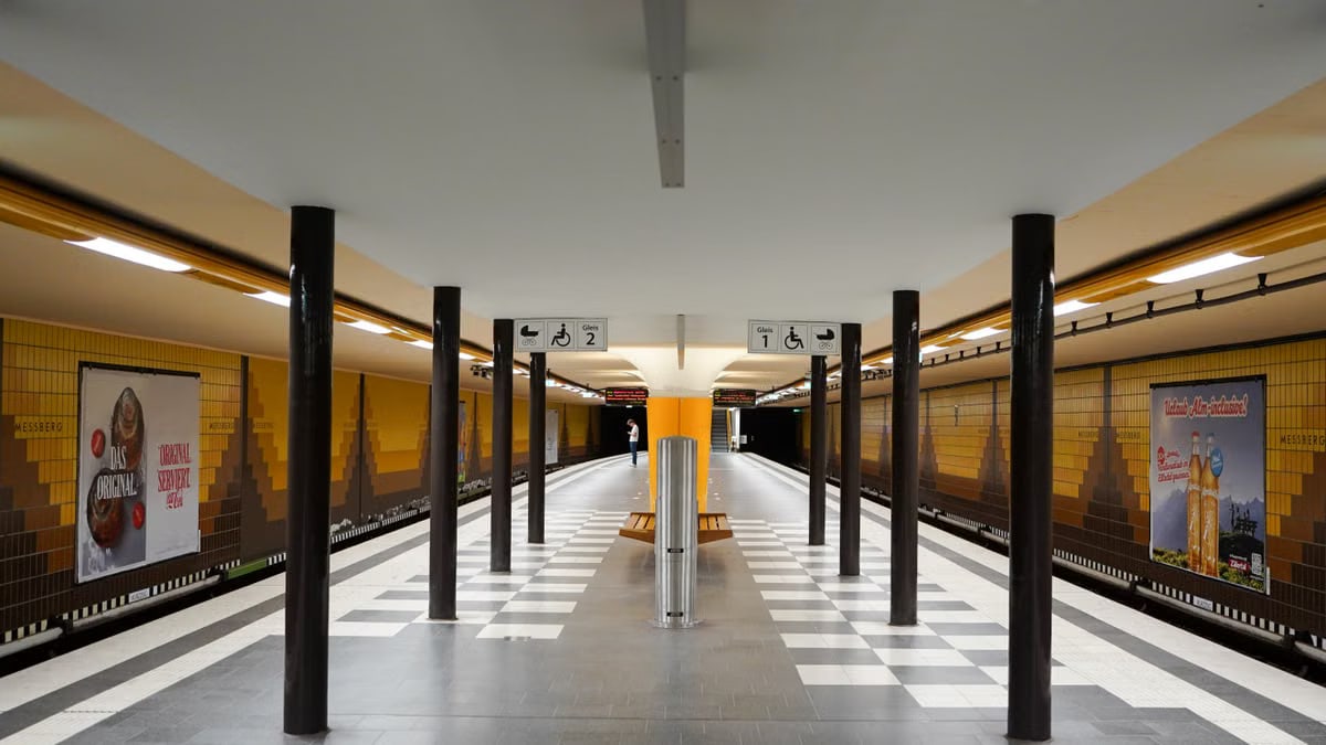 Interior view of an empty subway station platform in Hamburg, showcasing modern design and architecture.